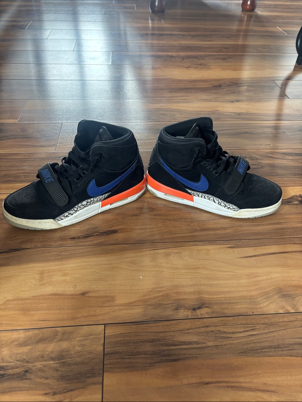 Jordan Nike Kids Black High-Top Sneakers with Blue Swoosh and Orange Accents